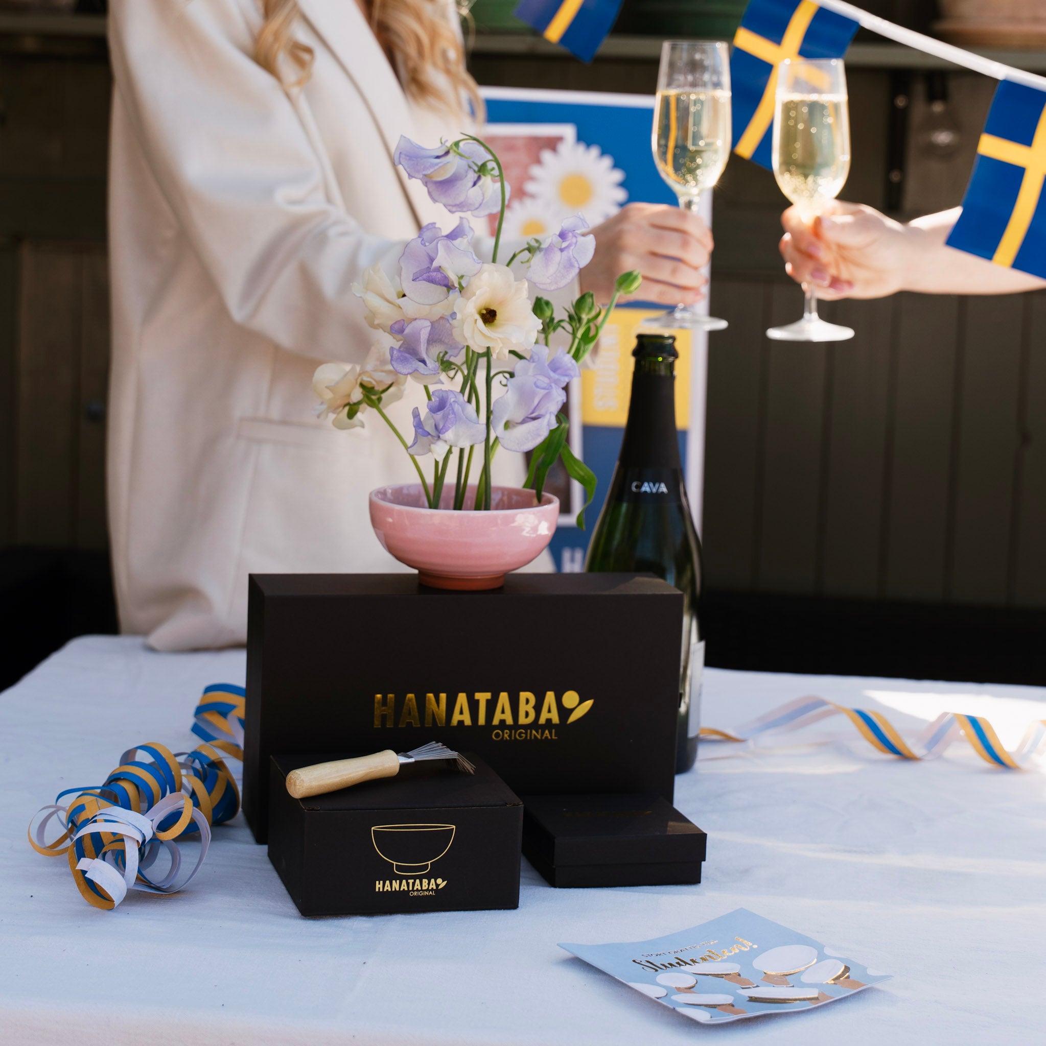 Table setting with Hanataba products, flowers, and champagne flutes.