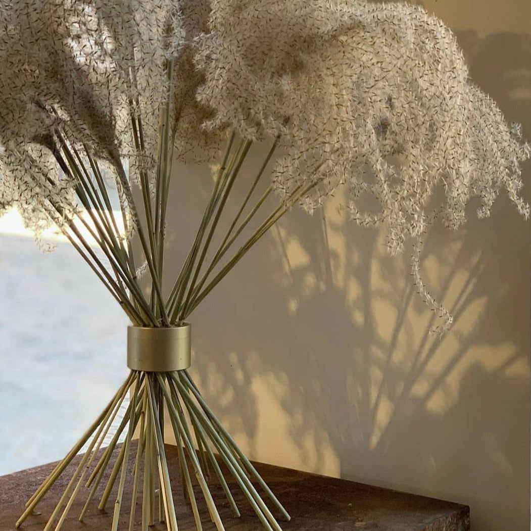 Ethereal shadows cast by delicate white flowers arranged with a Hanataba Champagne Gold Spiral Stem holder