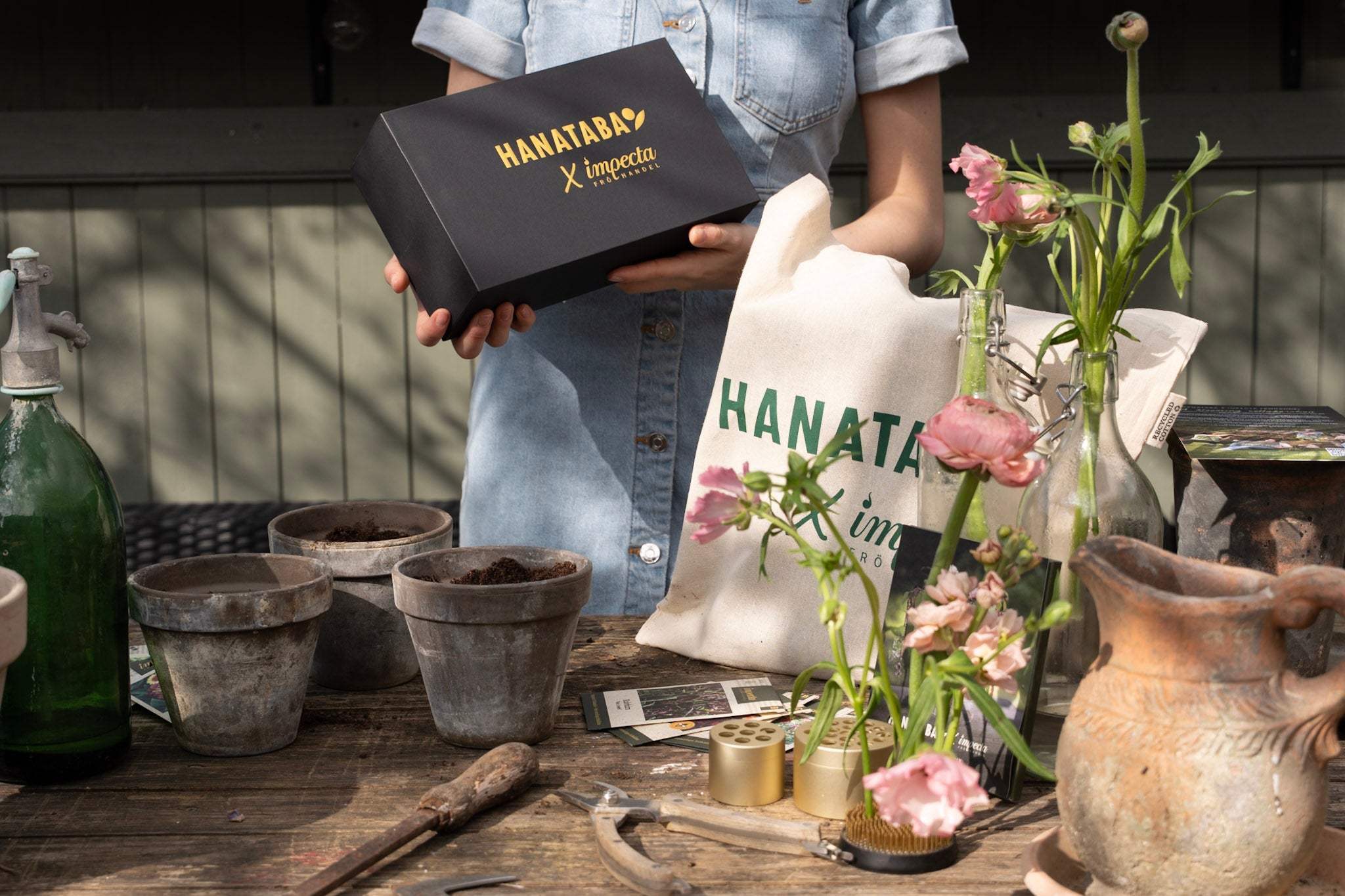 Hanataba x Impecta flower growing kit with tools and packaging on rustic table