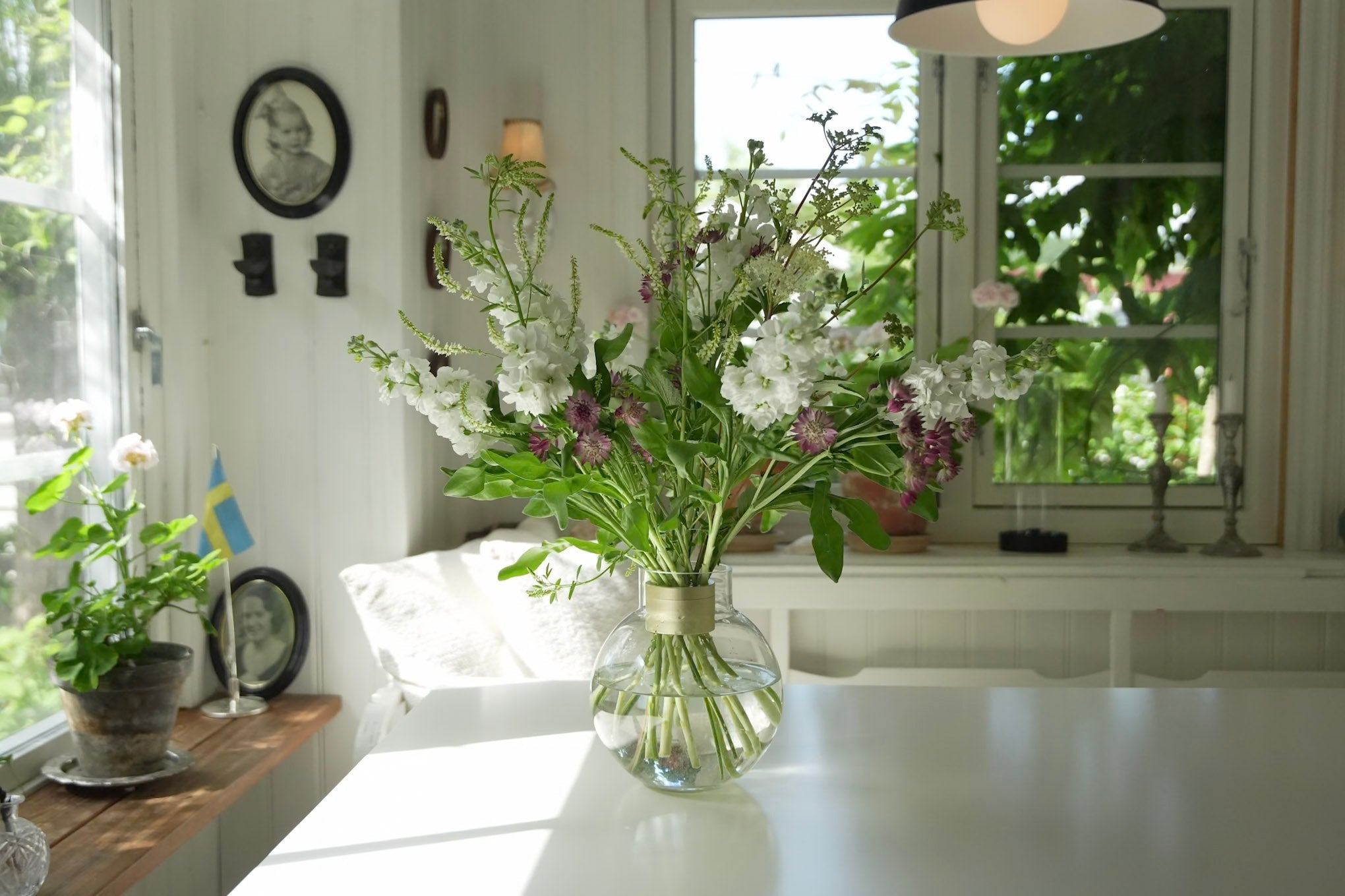 Wildflower bouquet in glass vase on table by window - Hanataba flowers for home decor