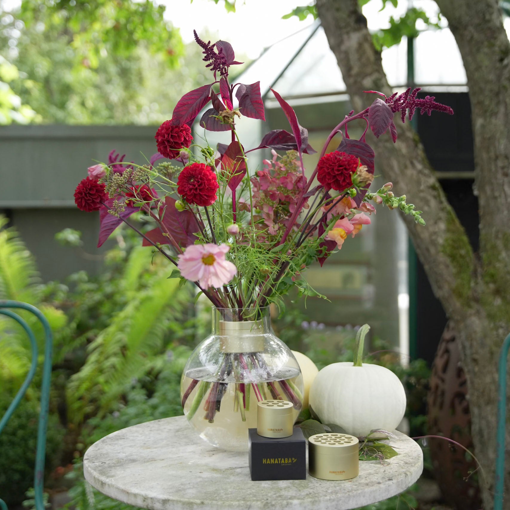 Autumn Floral arrangement with wine red flower branches and red dahlias inside a large Hanataba Bouquet Twister Champagne Gold 
