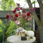 Autumn Floral arrangement with wine red flower branches and red dahlias inside a large Hanataba Bouquet Twister Champagne Gold 