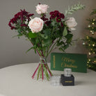 Elegant flower bouquet arranged with Hanataba Crystal Clear, displayed beside the green Merry Christmas gift box. The perfect holiday gift for floral design lovers.