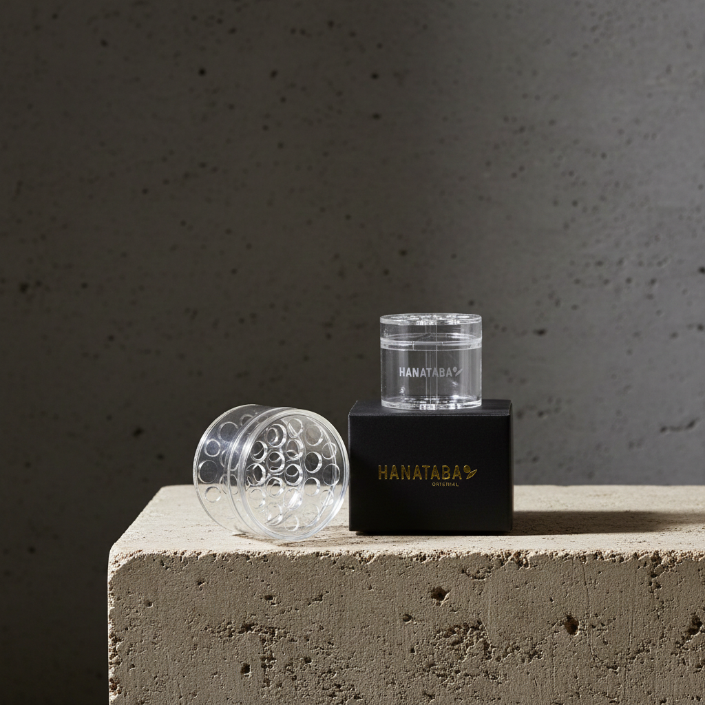 Hanataba Bouquet flower twister in color 'Crystal Clear' with a black paper box, labeled 'Hanataba' standing on a stone piedestal