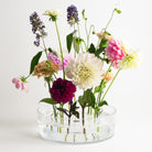 Hanataba Acrylic Cylinder Vase displaying a vibrant arrangement of dahlias, carnations, and garden flowers held upright with a Hanataba acrylic kenzan flower frog ring 150 mm.