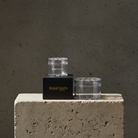 Two clear Hanataba bouquet flower twisters used for creating bouquets without experience. 2 sizes, large and small fitting from 7 to 30 flowers through the holes. Standing on a concrete stand with 'HANATABA' branding against a gray background.