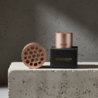 2 rose gold metal Hanataba bouquet flower twister made for creating beutiful bouquets at home without experience and black box with 'HANATABA' branding on a concrete surface.
