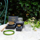 Gardening tools and supplies including a silicone disc 3-pack, transparent Bouquet Flower Twisters, and a green bonsai wire from Hanataba Original, standing on a white surface with a natural background.