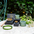 Collection of gardening tools and accessories by Hanataba Original, standing on a table with a natural background