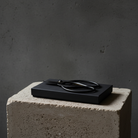 Black hanataba japanese scissor on a concrete block with a dark background