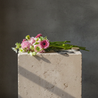 Bouquet of pink flowers with a hanataba japanese scissor and kenzan 70 mm on a concrete block with a dark background