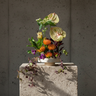 Hanataba Kenzan ring 200 mm (7 \ 7/8") luxury flower arrangement on a stone block in front of a dark grey background