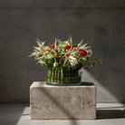 Hanataba Kenzan ring 200 mm (7 \ 7/8") flower arrangement with amaryllis and ranunculus in a glass vase on a stone block in front of a dark grey background
