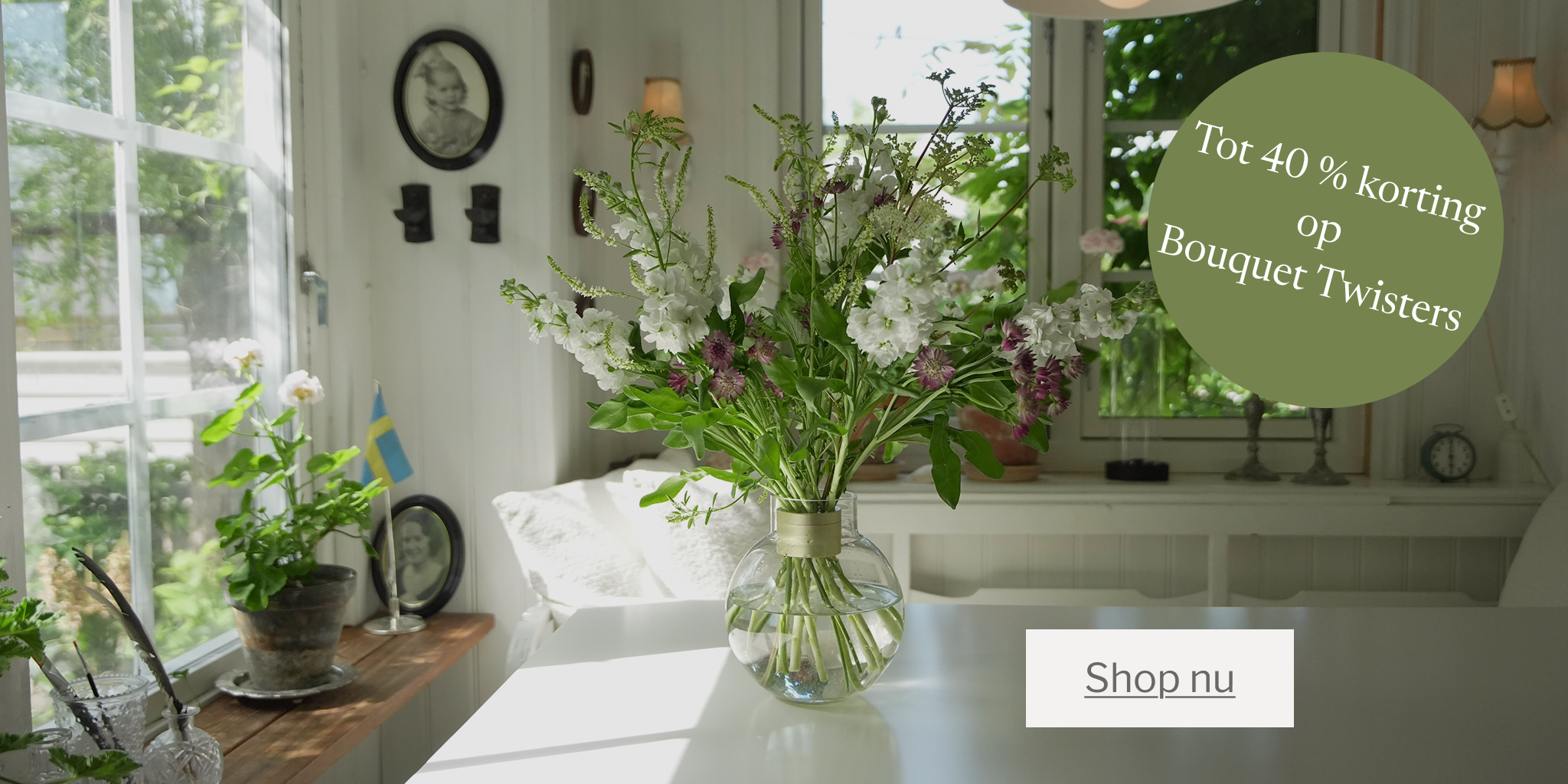 Living room with flowers and a promotional banner for Bouquet Twisters