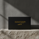 Black box with 'HANATABA' logo on a stone surface with a gray background