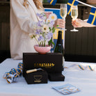 Table setting with Hanataba products, flowers, and champagne flutes.
