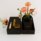 Floral arrangement in a black container with 'HANATABA' branding on a white background