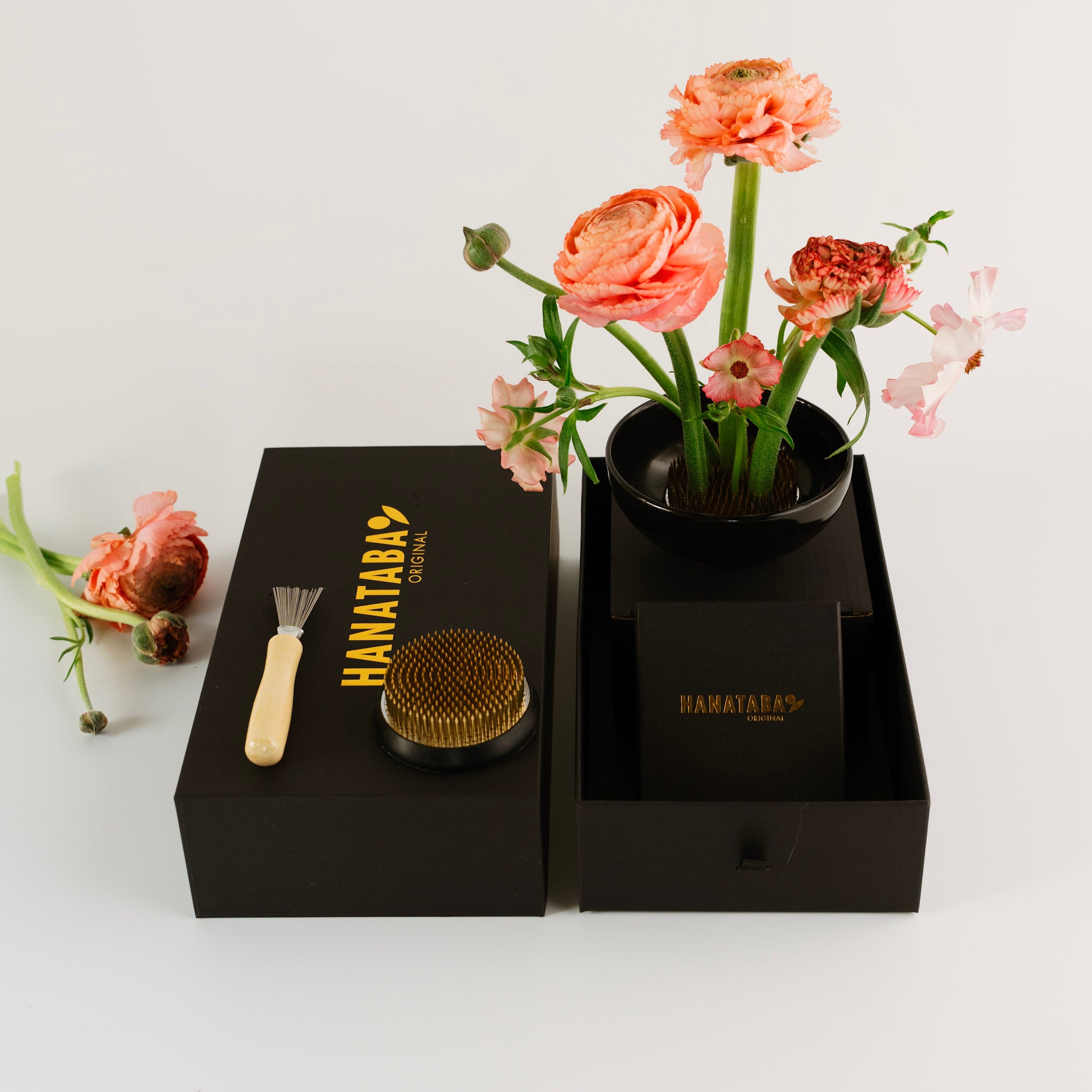 Floral arrangement in a black container with 'HANATABA' branding on a white background