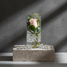 pink rose inside a cylindrical glass vase filled with hanataba water pearl beads