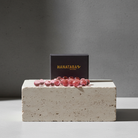 Gleaming pink water bubbles scattered in front of a 'HANATABA ORIGINAL' box, for crafting elegant flower displays.