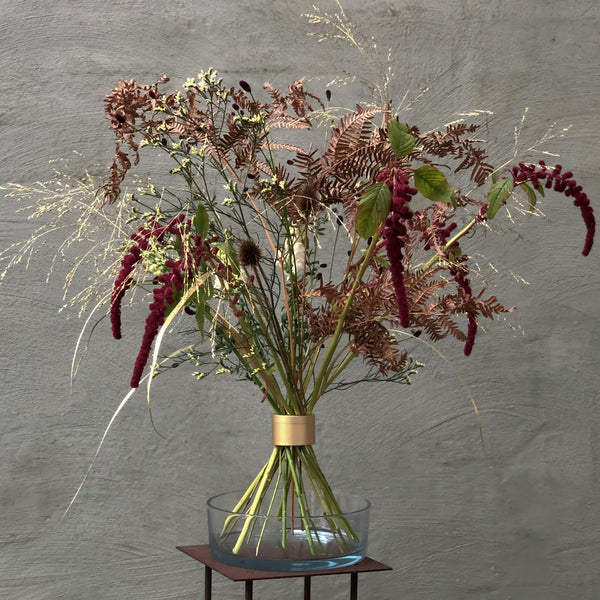 Autumnal Ikebana display with red amaranths and ferns, artistically secured by a Hanataba Spiral Stem holder.