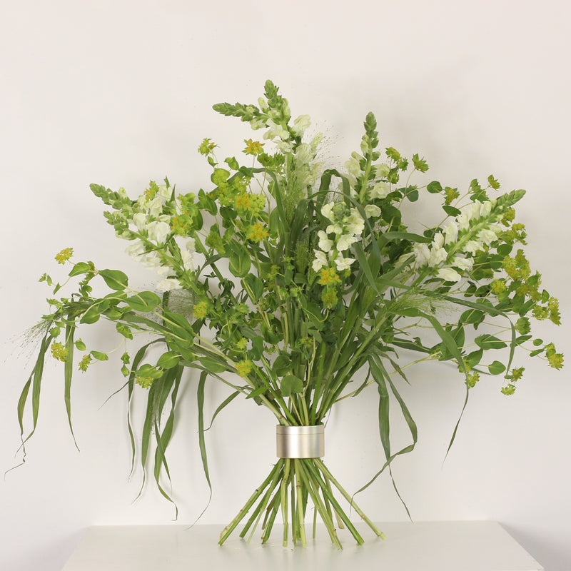 An Ikebana-inspired floral arrangement in full bloom, secured by a Bouquet Twister, showcasing a harmony of white and yellow flowers