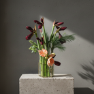 Lisign MILANO Vase with flowers on a gray surface against a dark background